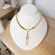 iconic love drop necklace gold chain with pave love pendant on display