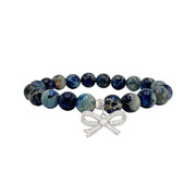 blue sea sediment jasper bow bracelet with natural deep blue patterned beads and gold bow charm