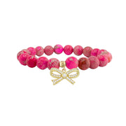 pink sea sediment jasper bracelet with natural marbled pink gemstone beads and sparkling bow charm