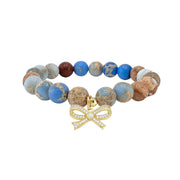 sand blue sea sediment jasper bracelet with beige blue mixed gemstone tones and bow charm