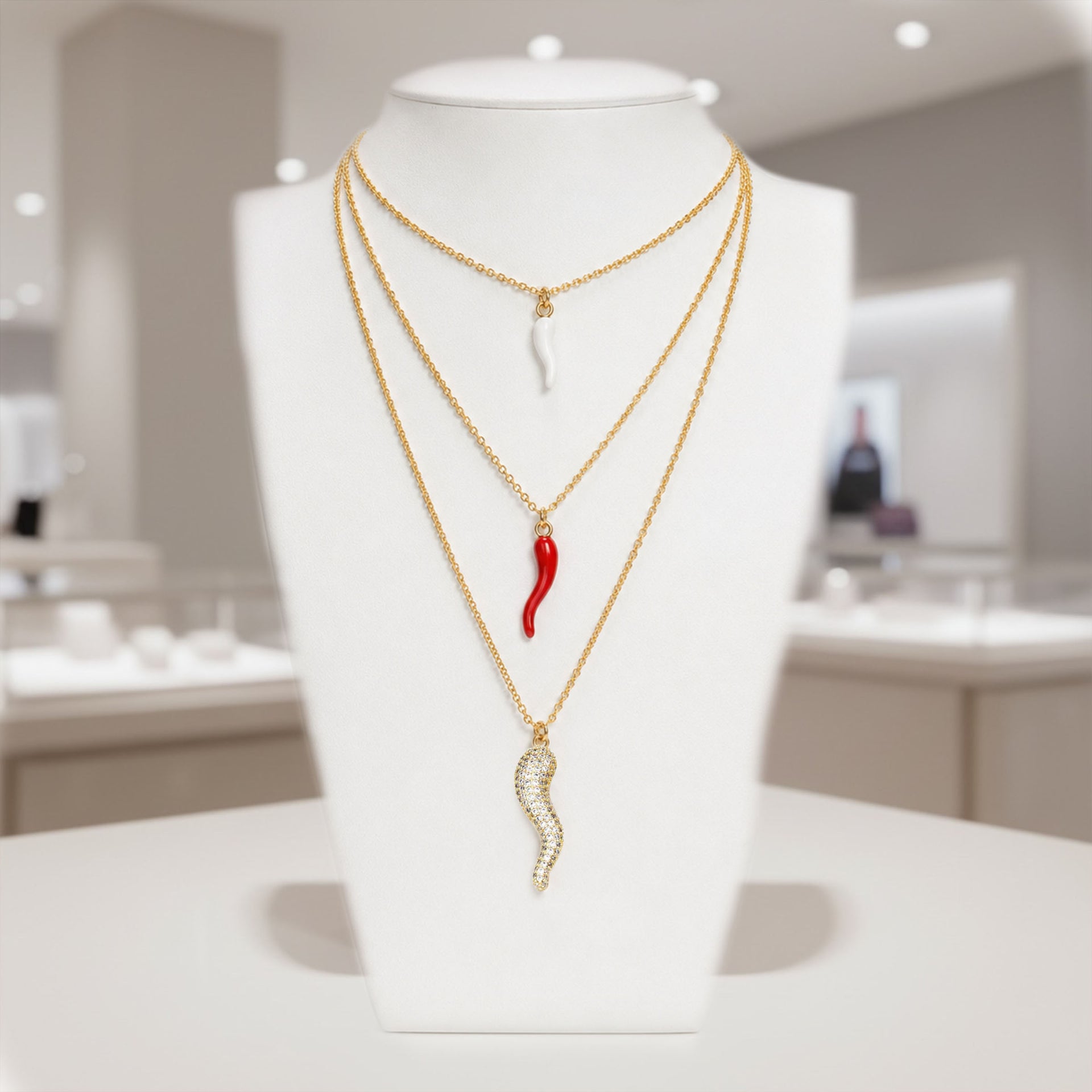 Love Lisa Italian horn necklace display with layered gold and silver pendant styles on jewelry bust