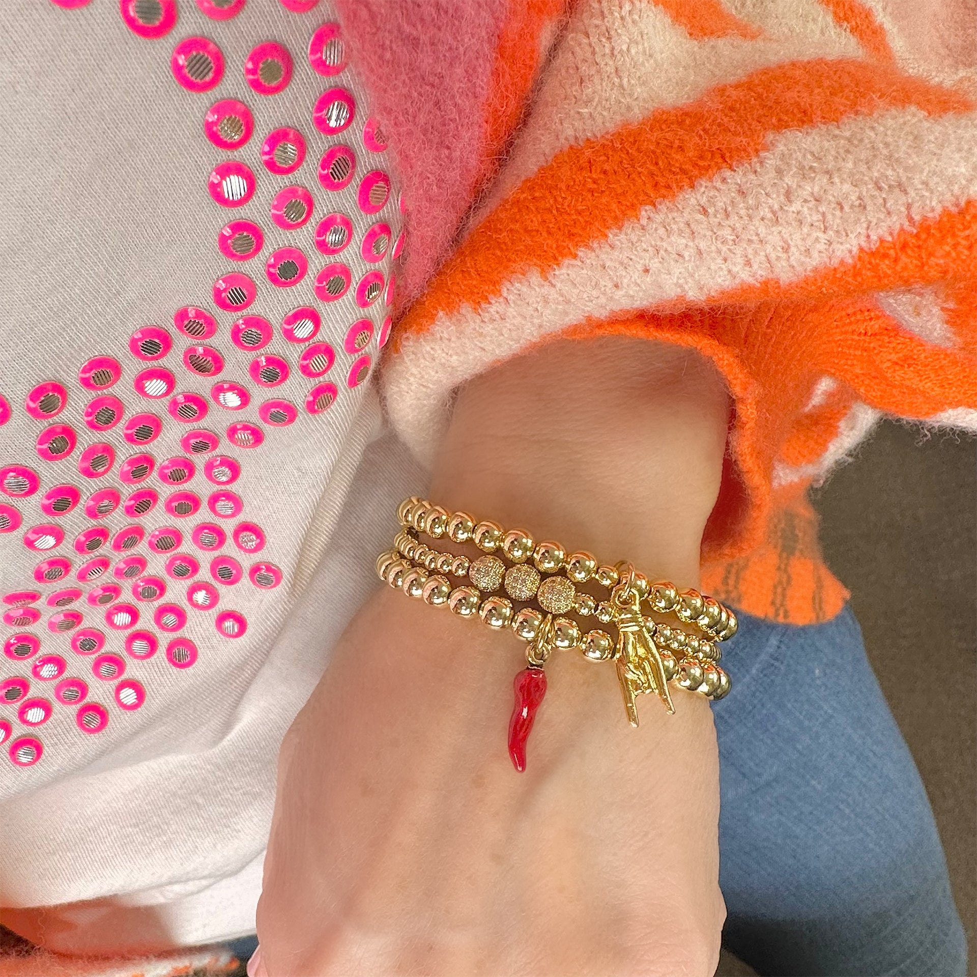 italian red horn cornicello bracelet gold worn on model showing red horn pendant love lisa
