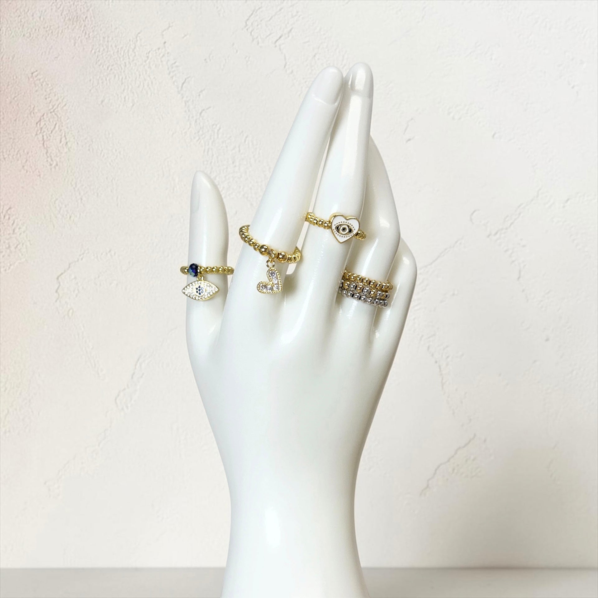 Love Lisa Jaime Trifecta Stretch Ring Set displayed on hand form with three mixed metal stretch rings