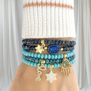 Jewish charm bracelet stack with Star of David - Evil Eye - Hamsa Hand - and Love script from Love Lisa Jewelry
