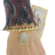 love lisa joan of arc courage bracelet on wrist gold beaded bracelet with joan of arc medal spiritual inspirational jewelry