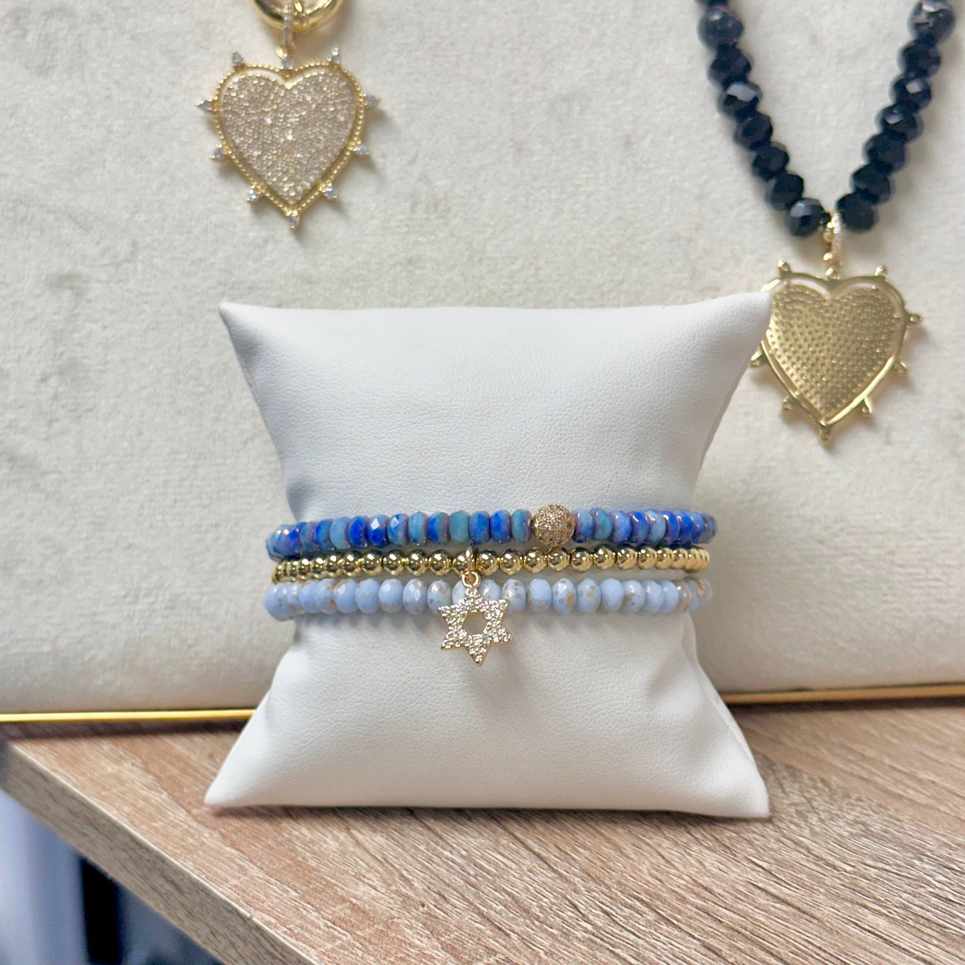 love lisa julie star of david bracelet stack displayed on pillow crystal and gold beaded bracelets with star of david charm