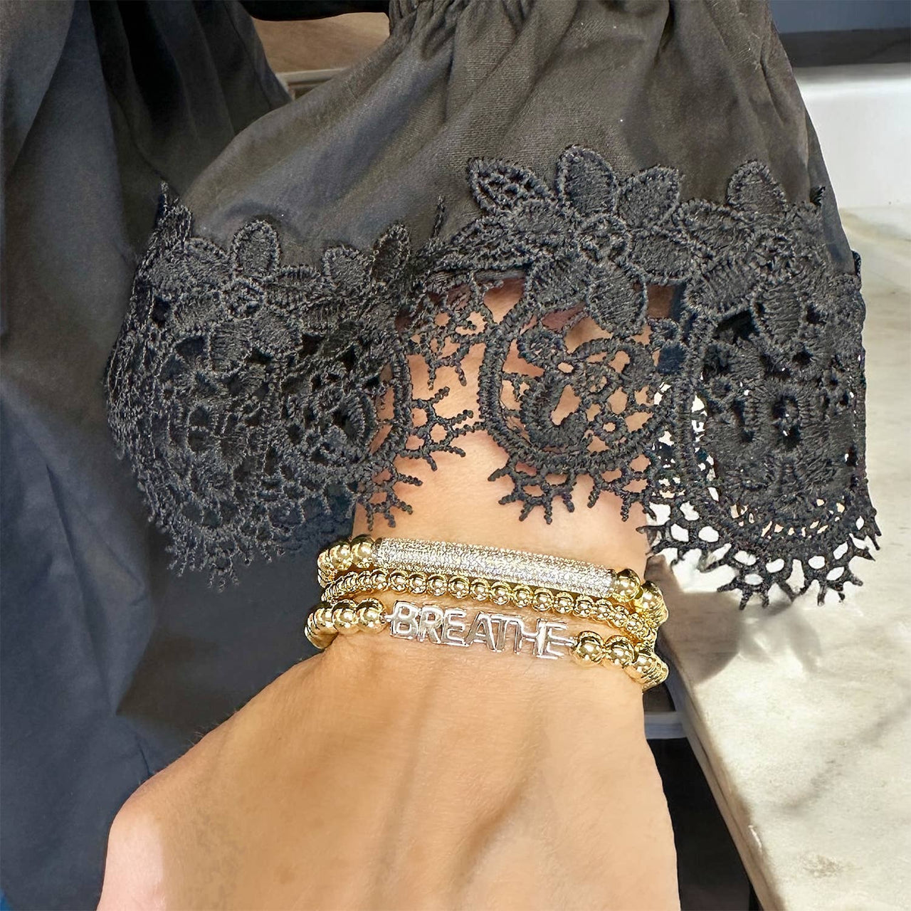 karens powerful reminder bracelet breathe gold beaded bracelet with inspirational charm on wrist