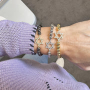 star of bracelet layered on a model in the love lisa showroom