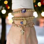 love lisa larissa cross stretch bracelet on wrist stacked beaded bracelets with crystal cross charm