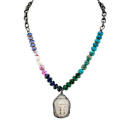 A beaded necklace with a Buddha head pendant, featuring a gunmetal chain and multicolored beads.