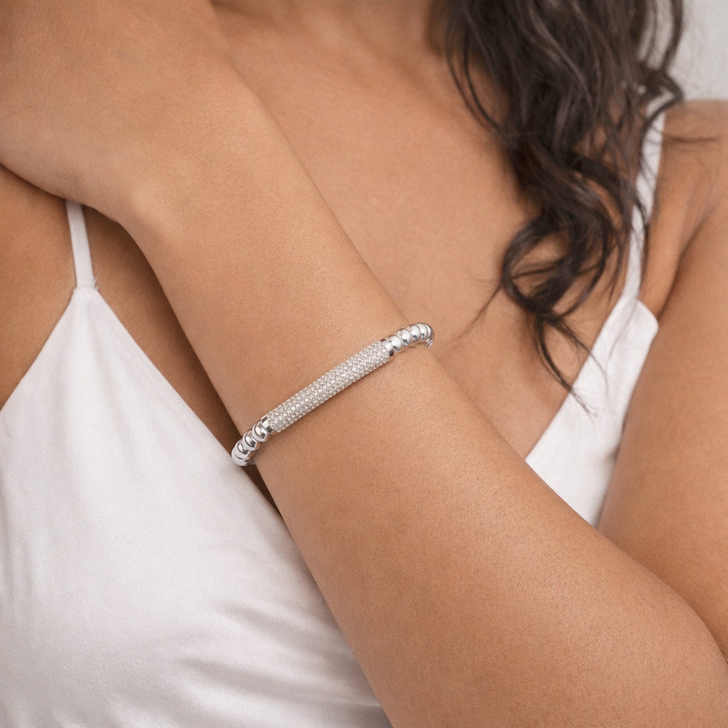 Lexi Crystal Bar Bracelet silver worn on wrist with polished bead stretch bracelet