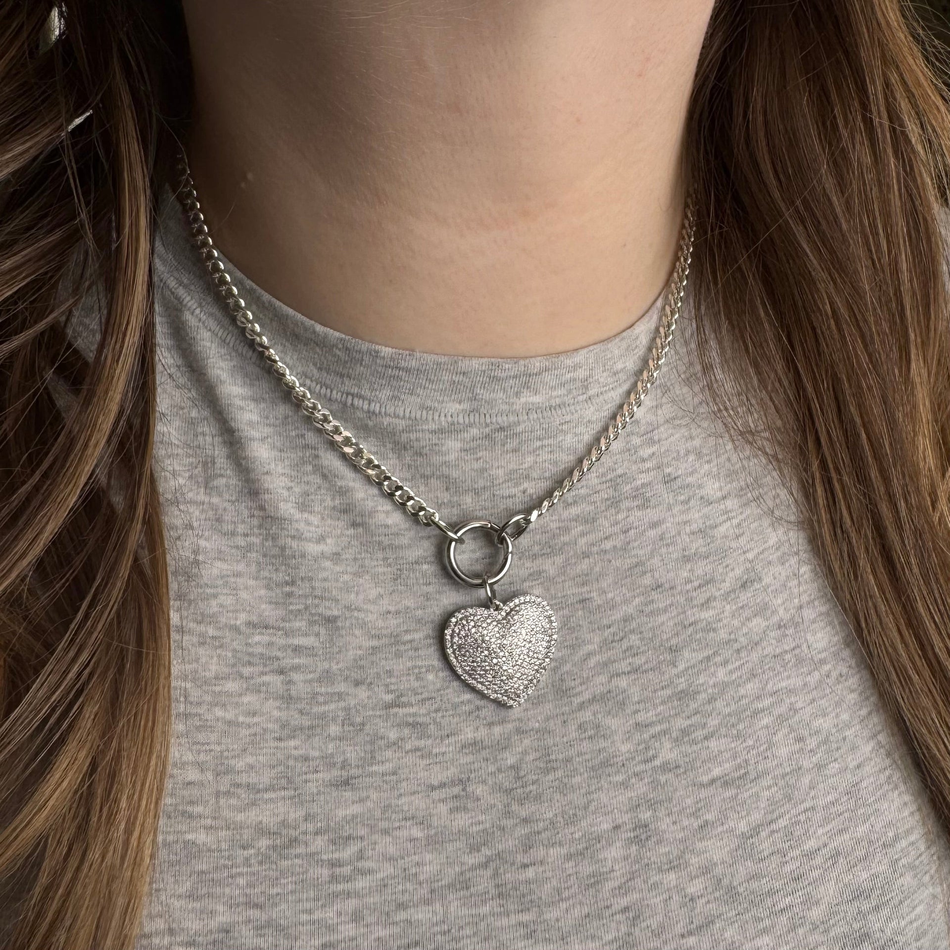 Shiny silver heart pendant with glittering rhinestones on chain