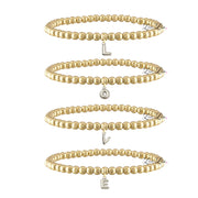 three gold bubble letter initial bracelets stacked vertically with dangling letter charms