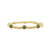 gold lilly pave bracelet styled with green pave accent charm paired with smooth beads