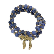 Liora Gemstone Beaded Chai Necklace coiled with deep blue sodalite beads, gold-tone accent beads, and engraved gold Chai to Life pendant