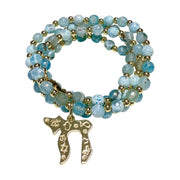 Liora Gemstone Beaded Chai Necklace coiled with pale blue Fire Agate beads, gold-tone accent beads, and engraved Chai to Life pendant