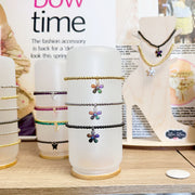 Display of Lisa Favorite Flower Anklets in gold silver and black with multicolor charms