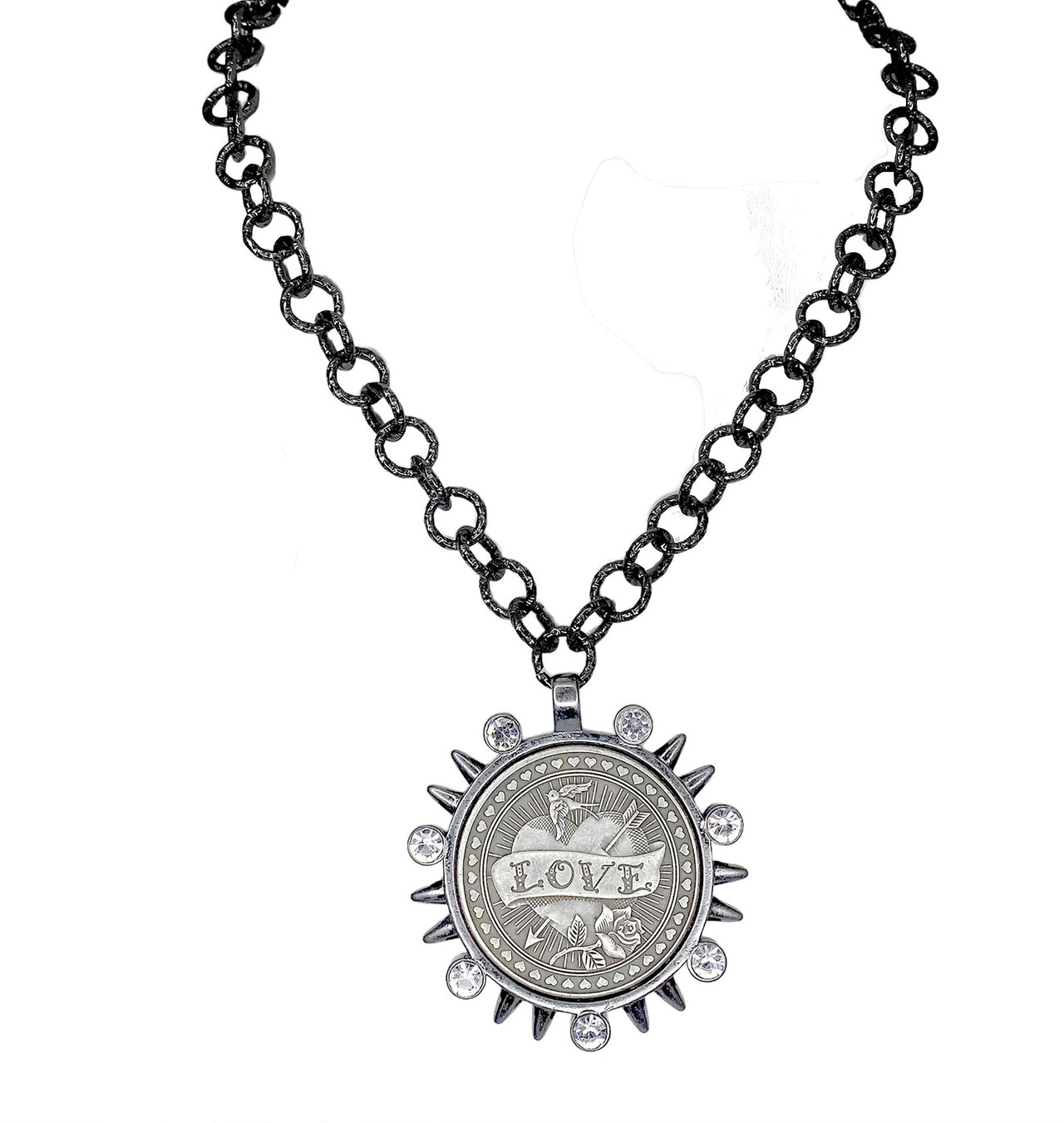 black chain necklace with large silver LOVE coin pendant surrounded by spike and crystal accents on white background