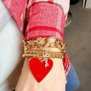 Love Lisa locked in love heart clasp bracelet layered with red and gold heart bracelet stack