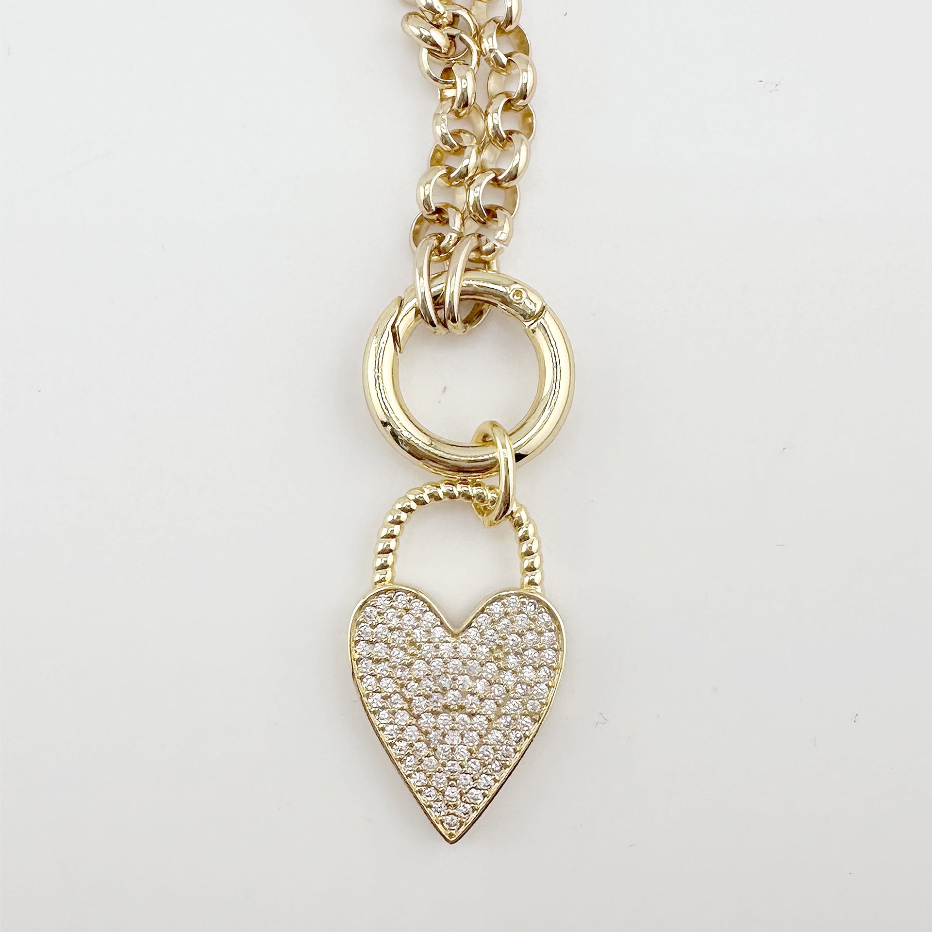 Gold pavé heart lock charm with twisted handle on large clasp

