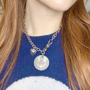 Model wearing Lolita Queen Bee Coin Necklace silver statement necklace layered with casual outfit