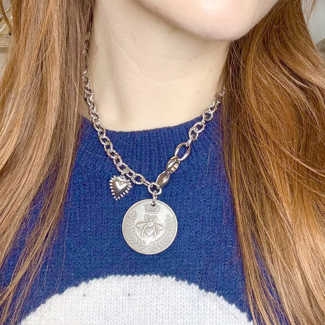 Model wearing Lolita Queen Bee Coin Necklace silver statement necklace layered with casual outfit