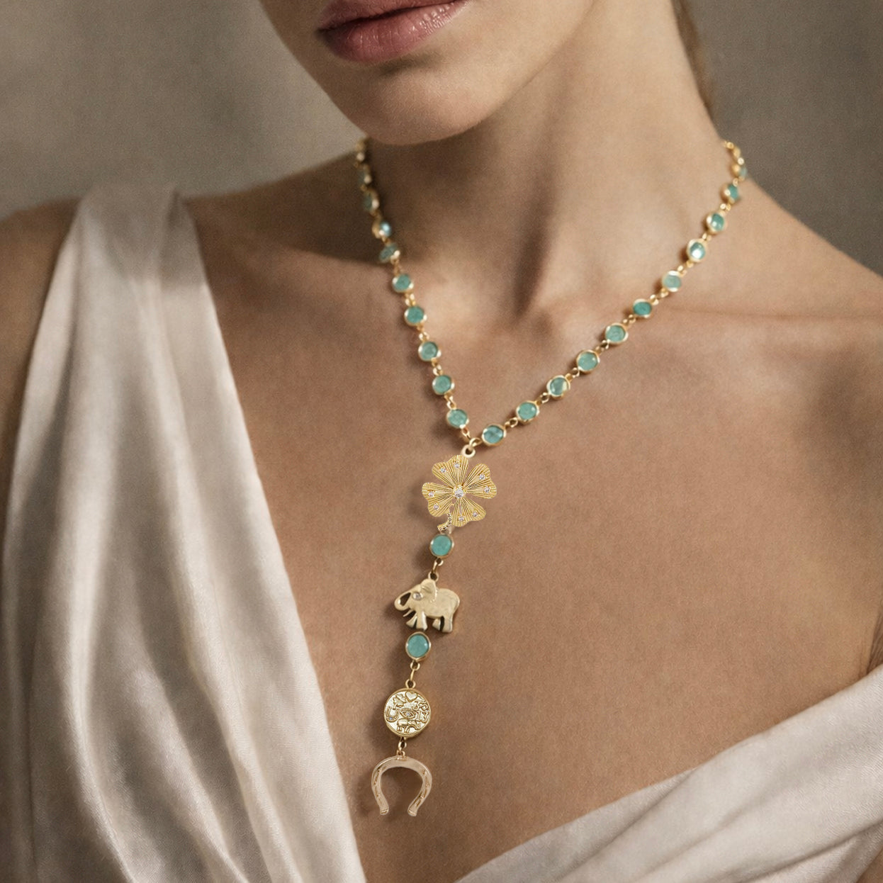 Love Lisa green stone lucky clover necklace worn layered showing gold chain and symbolic charms