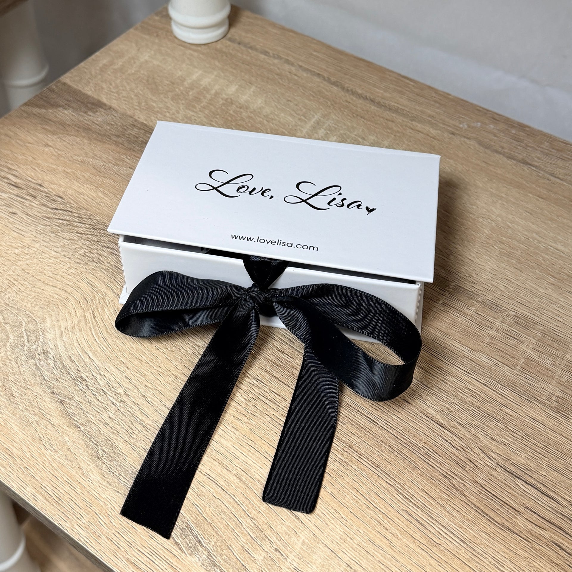 Jewelry gift box displaying necklace on black insert