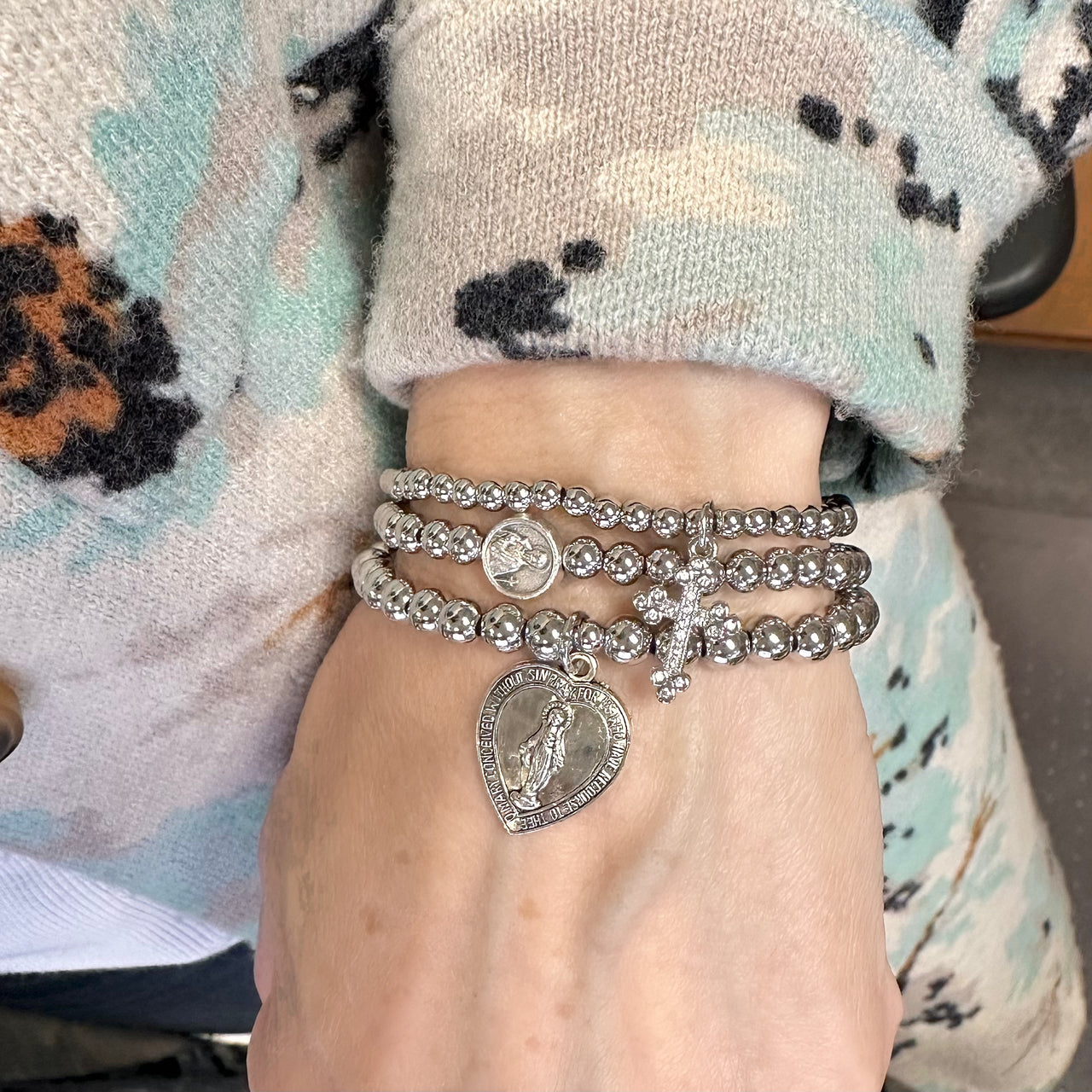 Love Lisa Saint Gerard beaded bracelet worn on wrist layered with faith jewelry