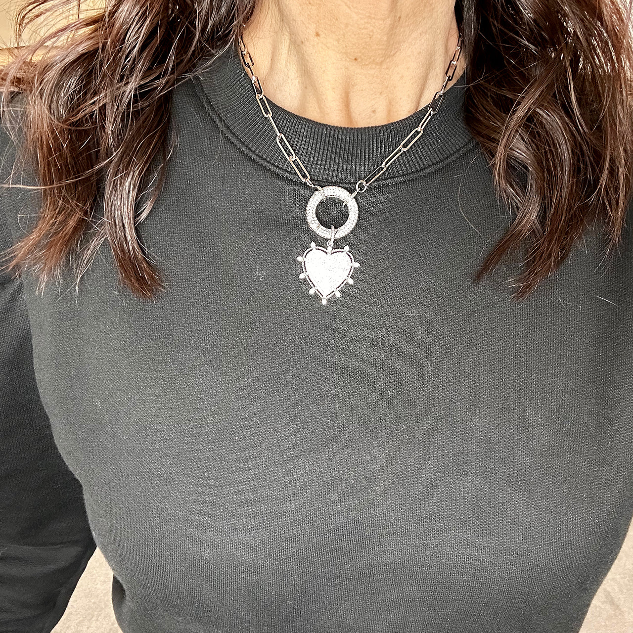woman wearing silver stellar heart necklace on black shirt