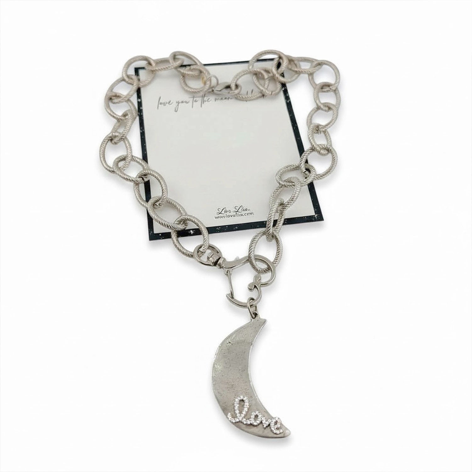 Silver chain bracelet with a moon-shaped charm on a white background