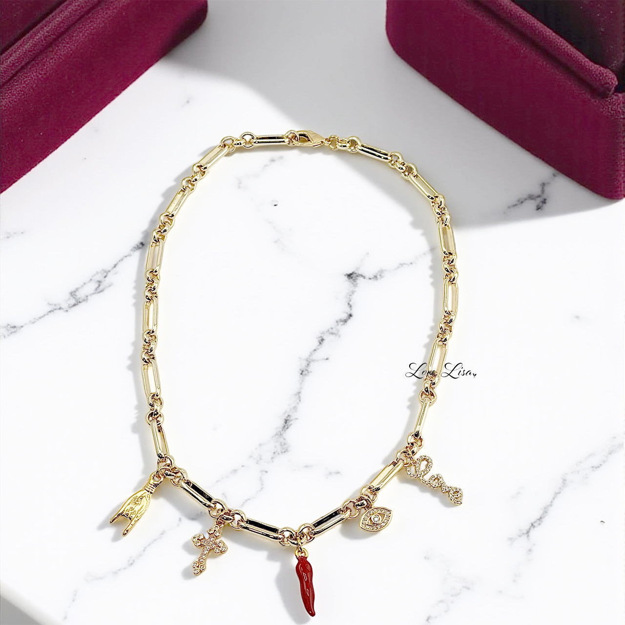 Luciana Italian horn charm necklace flat lay showing symbolic protection charms and bold chain