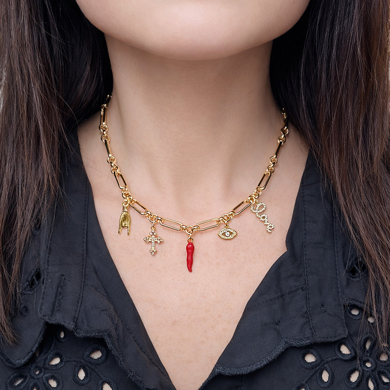 Love Lisa Luciana Italian horn charm necklace worn layered with symbolic charms on model