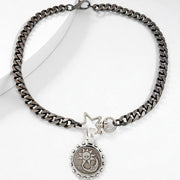 Silver chain necklace with a star and round pendant on a white background