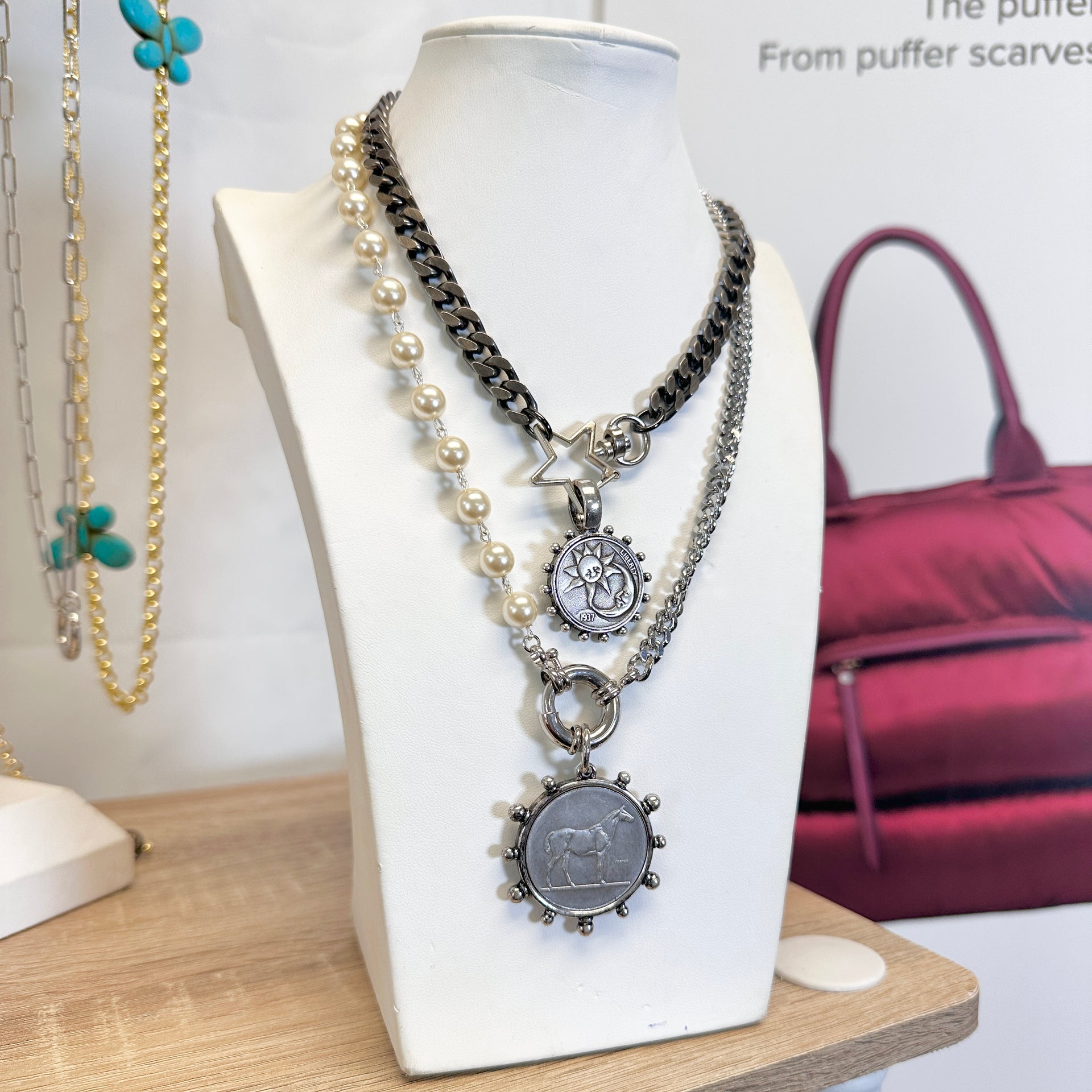 Necklace with pendants on a mannequin bust with a blurred background