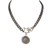 Necklace with star and circular pendant on a white background