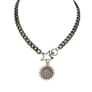 Necklace with star-shaped pendant and circular charm on a white background
