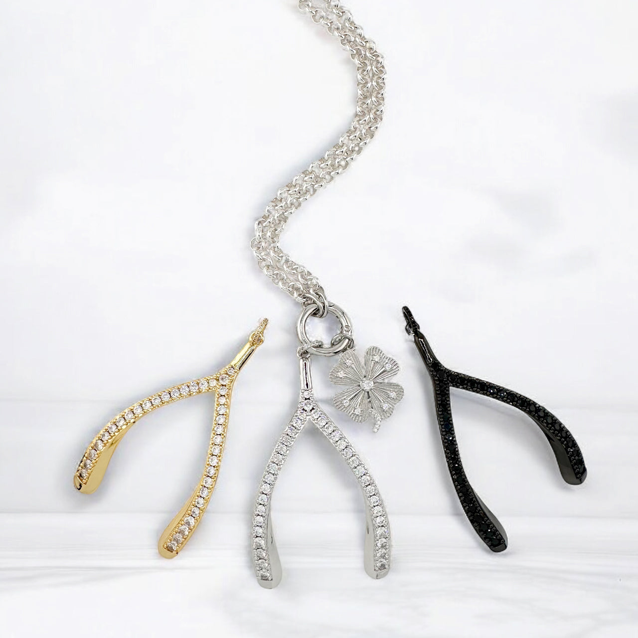 Luxe Wishbone Sparkle Charms in gold, silver, and black CZ styles on chain with clover charm