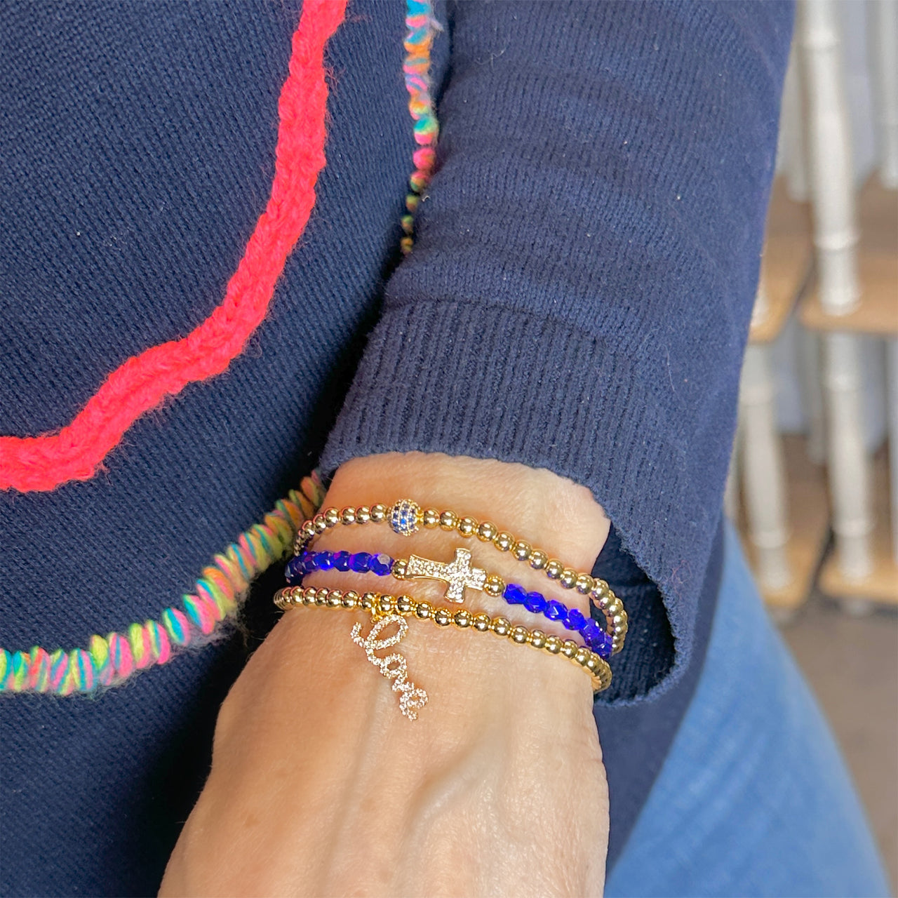 Colorful faceted crystal cross bracelets by Love, Lisa Jewelry on display