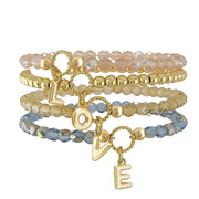 Love Lisa madison initial charm beaded bracelets stacked showing multiple colors and letter charms
