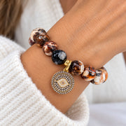 Love Lisa Amara Evil Eye Bracelet worn on wrist with faceted brown Fire Agate beads and round crystal evil eye charm