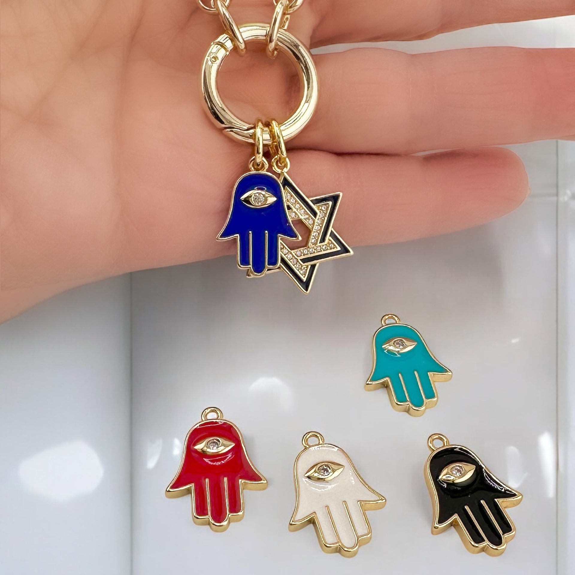 Gold Marcia Enamel Hamsa Charms with eye design in blue, red, white, black, and turquoise