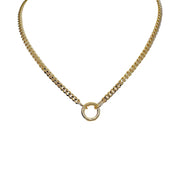 A silver curb chain necklace with a polished round clasp and three charms including a heart, a spiky heart, and a star.