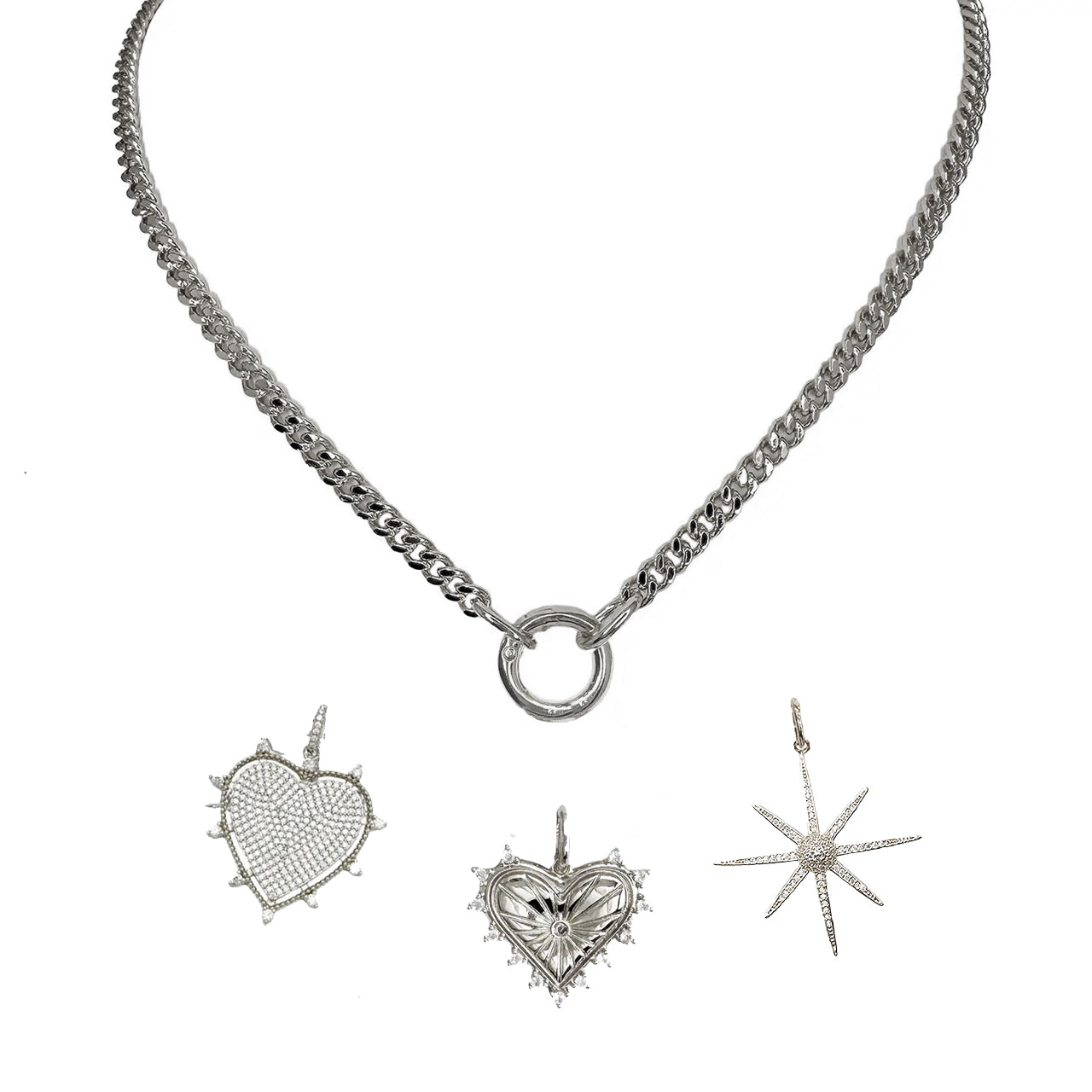 A silver curb chain necklace with a polished round clasp and three charms including a heart, a spiky heart, and a star.