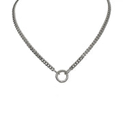 A silver curb chain necklace with a polished round clasp and three charms including a heart, a spiky heart, and a star.