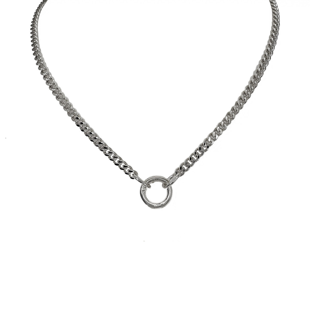 A silver curb chain necklace with a polished round clasp and three charms including a heart, a spiky heart, and a star.