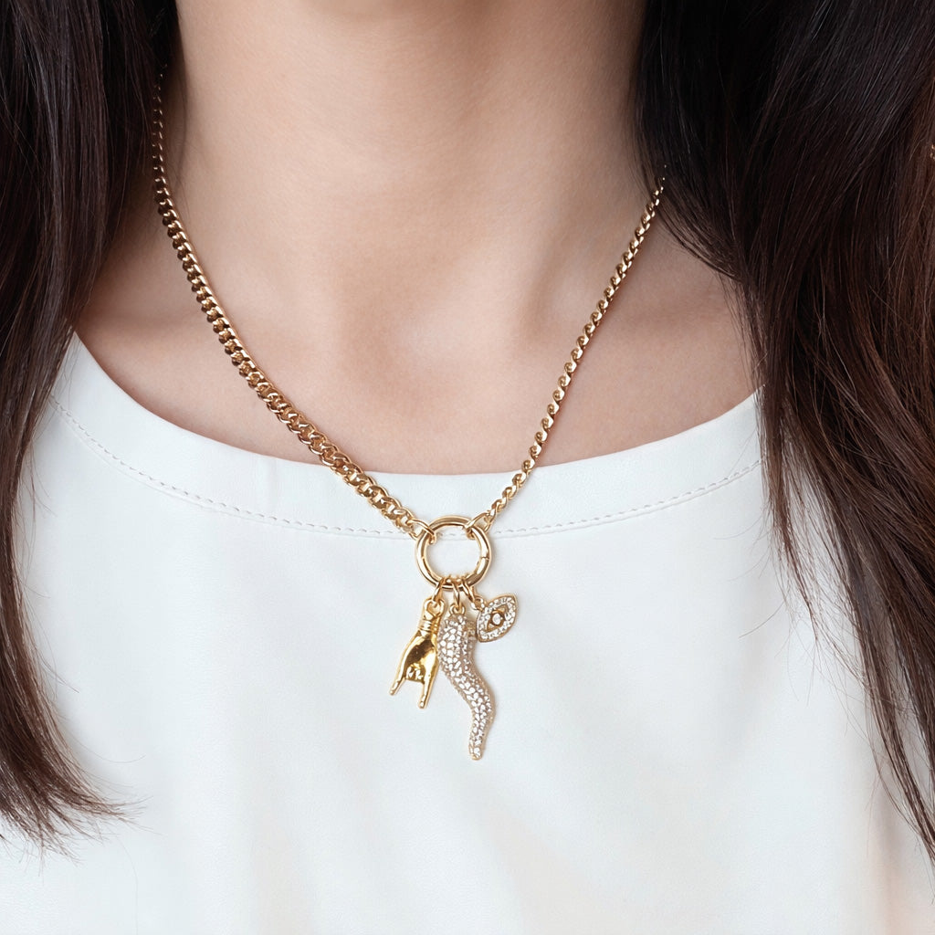 mariano gold italian horn charm necklace on a model wearing a white leather tee