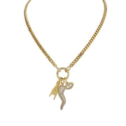 A gold-colored Italian horn (cornicello) necklace with multiple charms, including a hand and an evil eye, displayed against a white background.