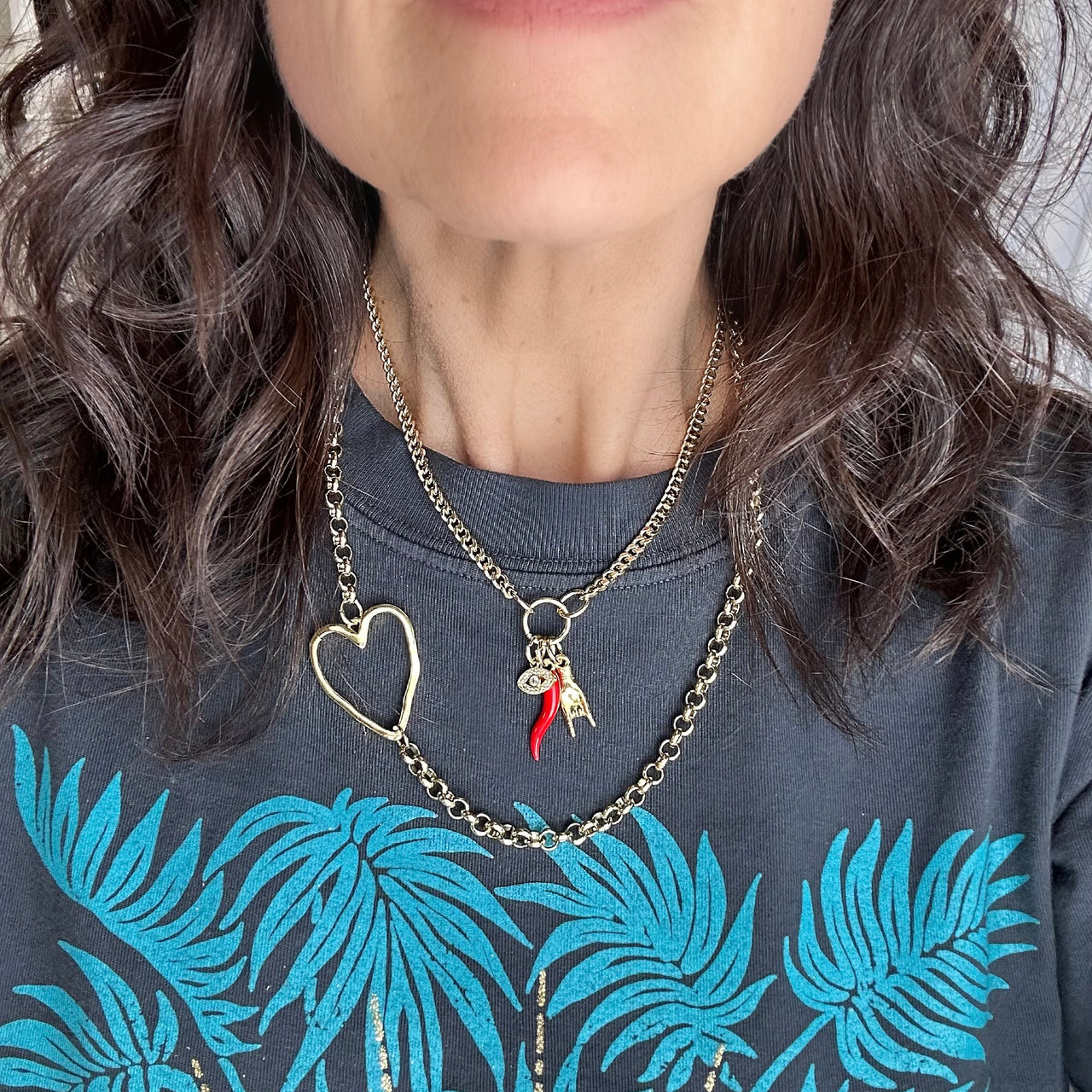 love lisa mariano italian protection charm necklace gold on model with cornicello evil eye and mano charms