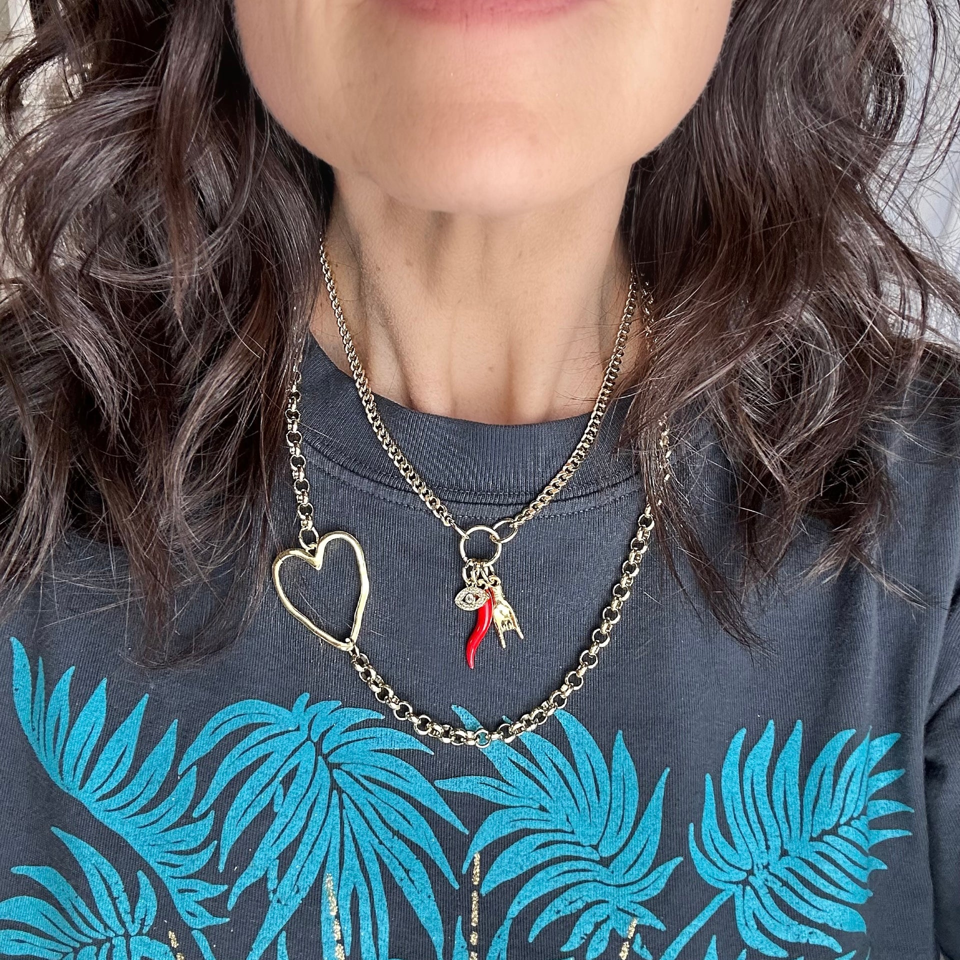 love lisa mariano italian protection charm necklace gold on model with cornicello evil eye and mano charms